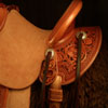 Wade tree, 15 inch seat, Gullet - 7 and 1/2 inch by 6 and 1/4 inch by 4 inch, Horn 4&1/2 inch round, 90 degree bars, 7/8ths full in-skirt riggin, Cheyenne Roll, Buckaroo outside leathers, half-breed Wade Saddle built and tooled with original floral and border design by Keith Valley.